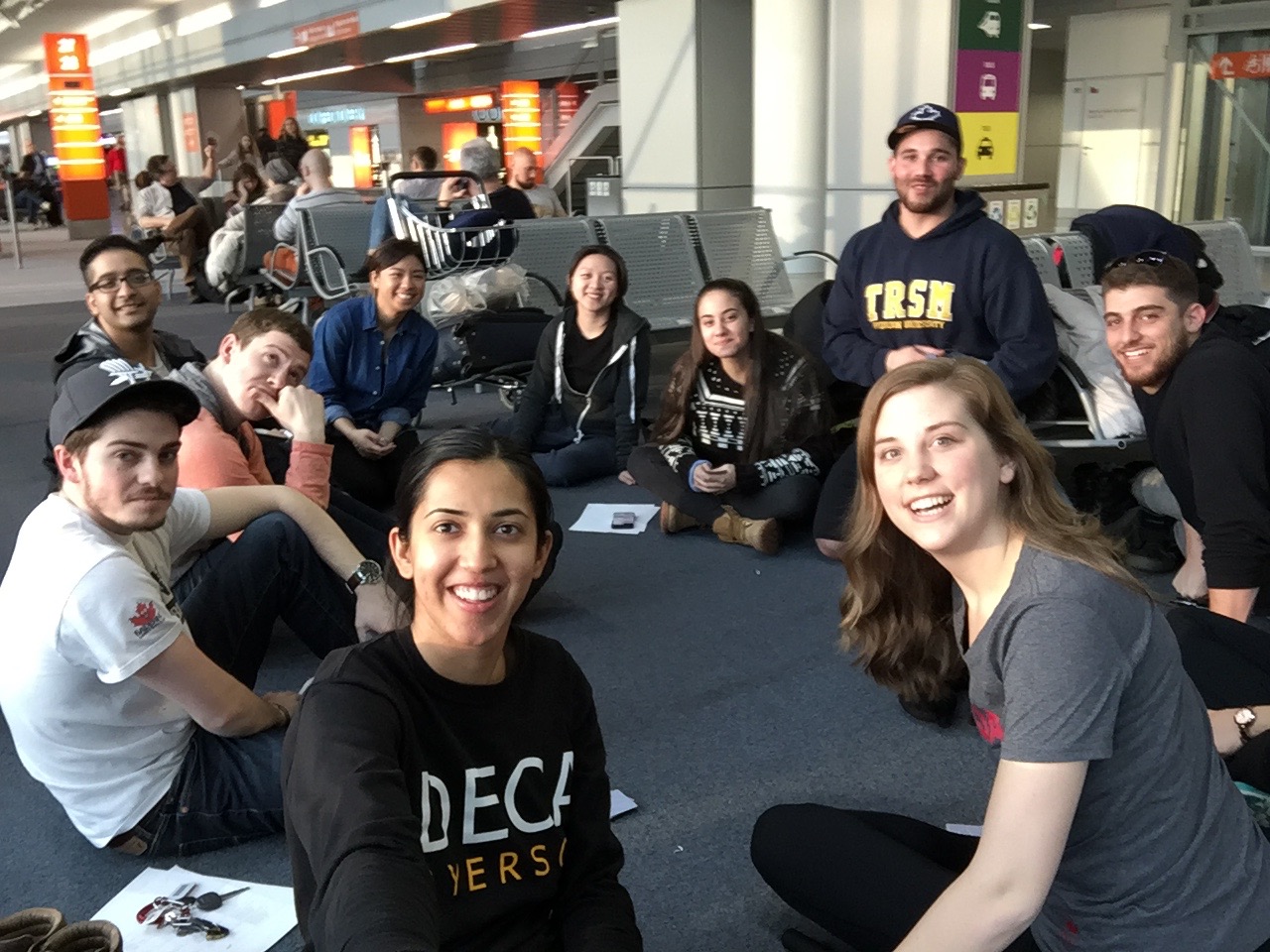 DECA students sitting in a circle at an airport